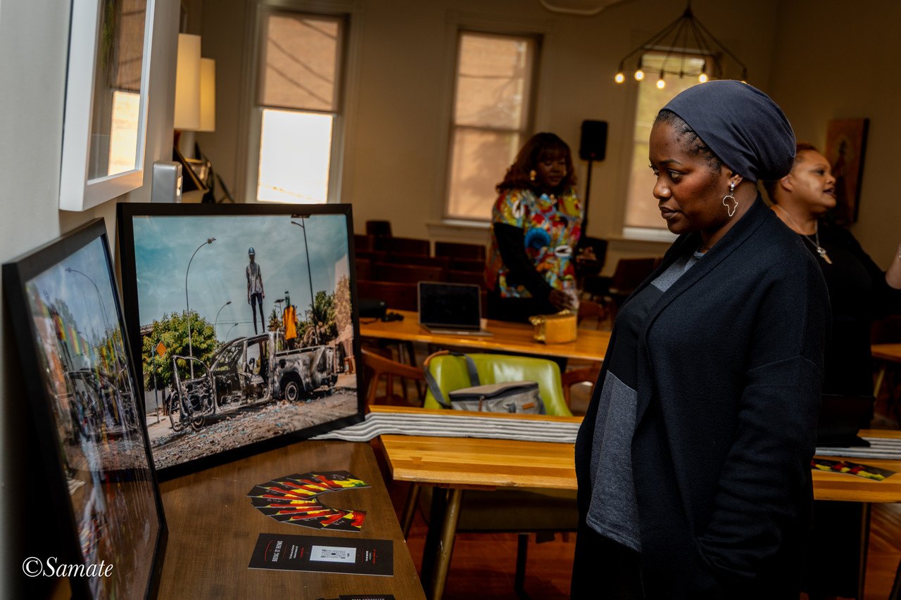 A guest intently viewing printed photographs at the ARC Institute Global launch event